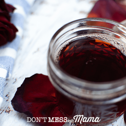 dark red rose water toner in glass jar
