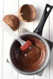 melted chocolate chips in a saucepan with a spatula