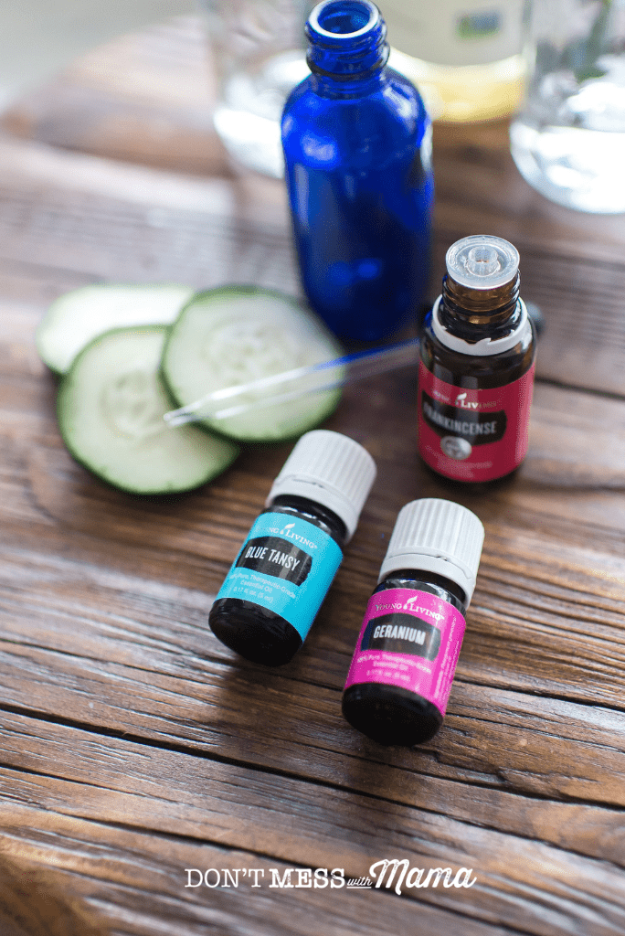 essential oils with cucumber and blue dropper bottle