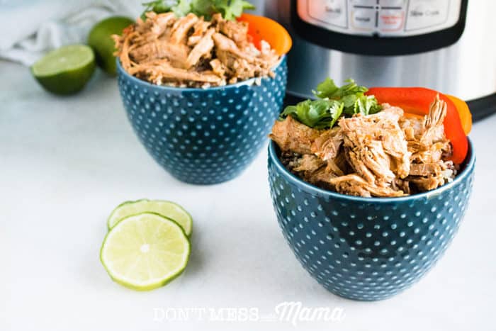 tywo blue bowls filled with pork carintas and lime wedges