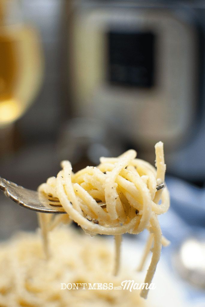 close up of fork with twirled spaghetti cacio e pepe