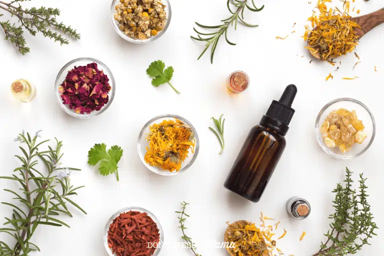 bottles of essential oils for clear skin on a table with dried flowers and herbs