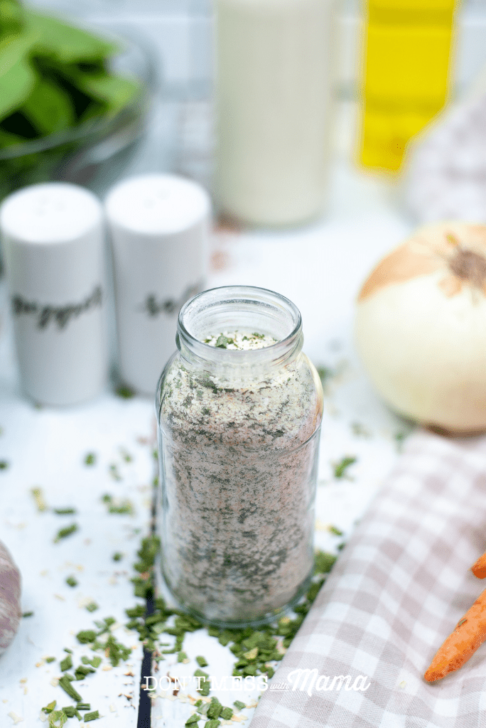 small glass bottle with dry ranch seasoning mix, onion and salt pepper shakers