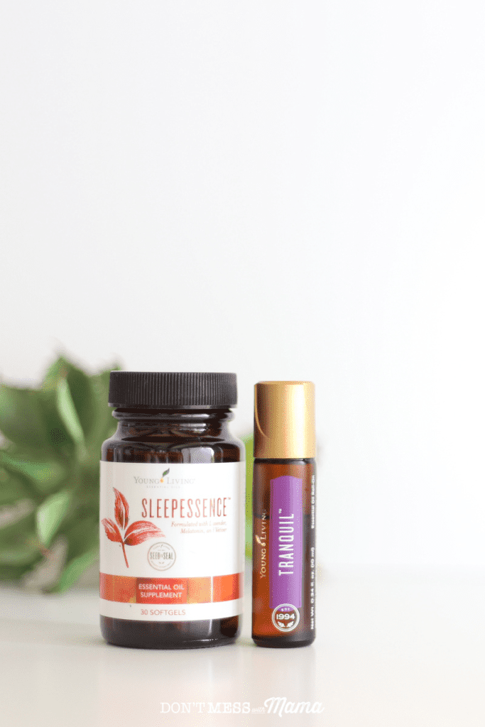 Sleep Essence supplement bottle on a table with Tranquil essential oil roll-on