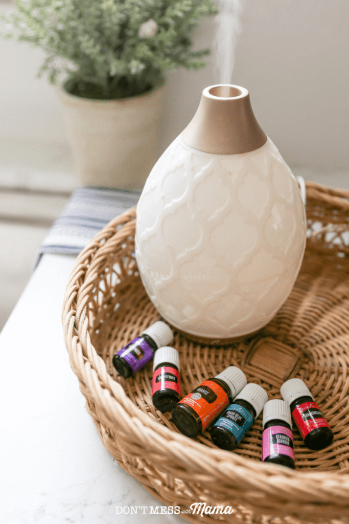 essential oil bottles in a basket with a diffuser