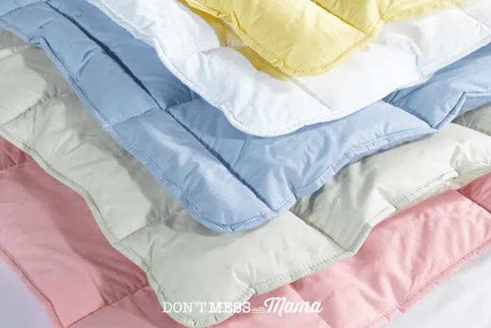 pink, green. blue,white and yellow blankets stacked