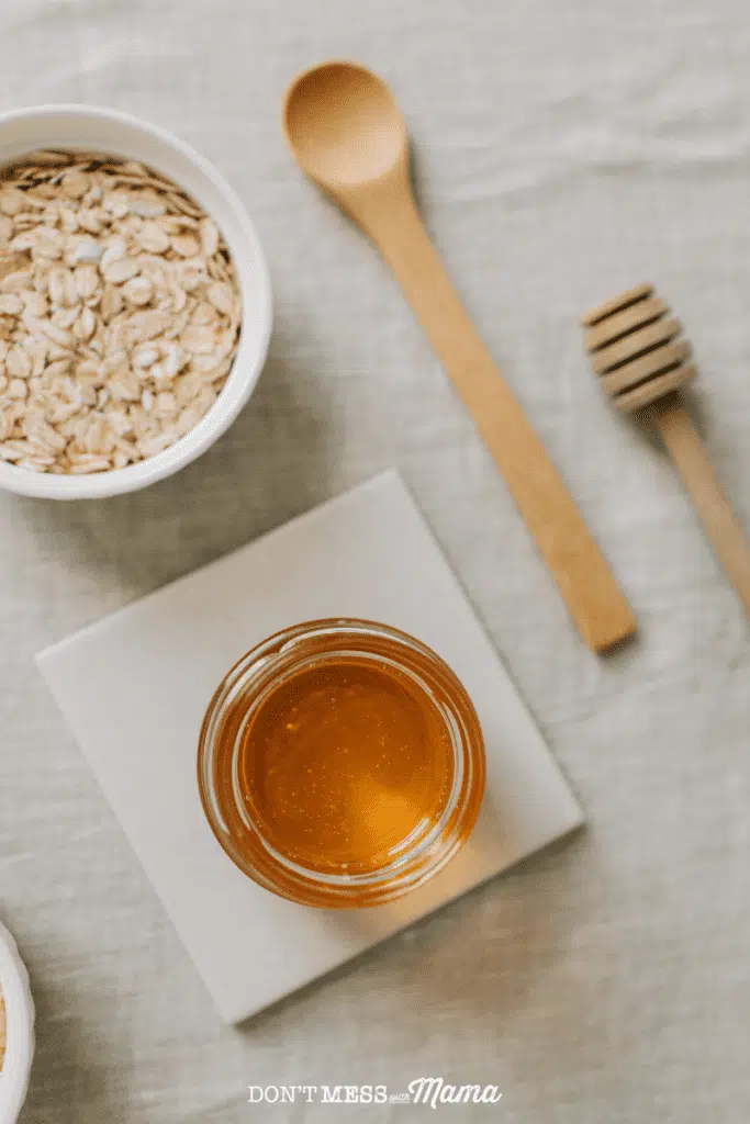 jar of honey with oatmeal and wooden spoon