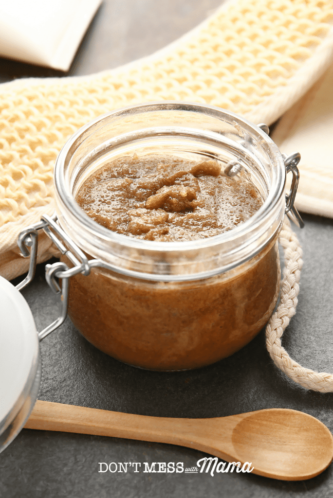 mason jar with homemade body scrub and wooden spoon