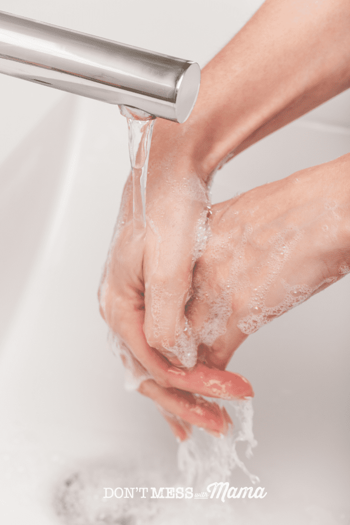 hands being washed under running tap