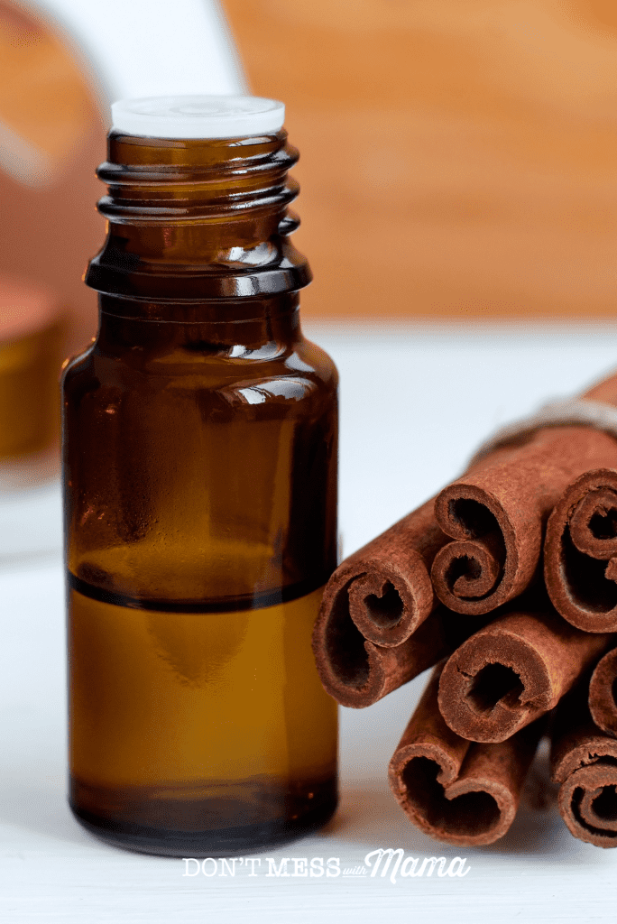 cinnamon sticks with essential oil bottle