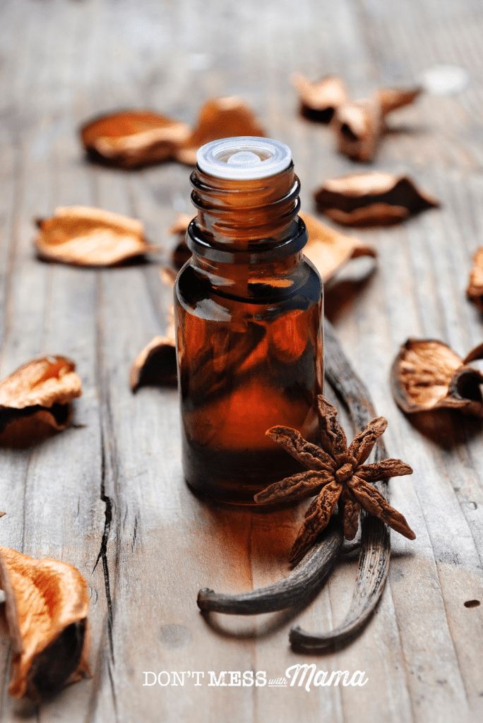 cinnamon essential oil with leaves in background