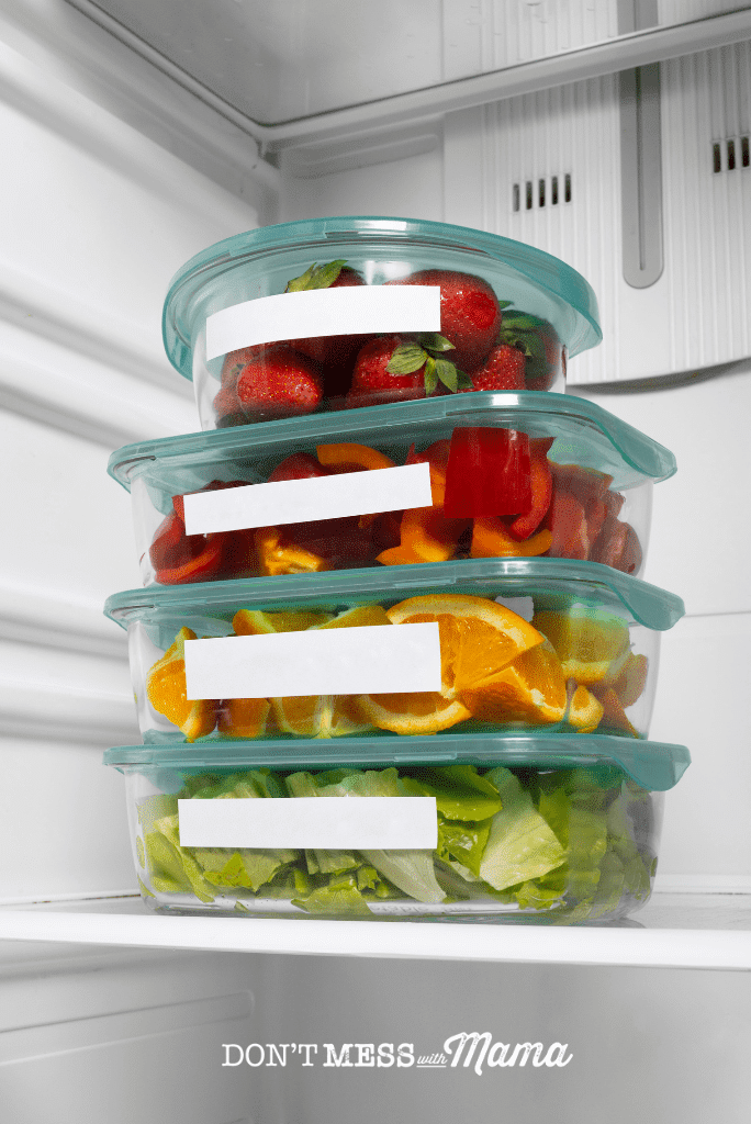 glass storage boxes in fridge filled with fruit