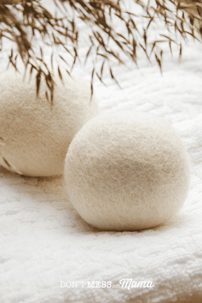 white dryer balls with pampas on white towel