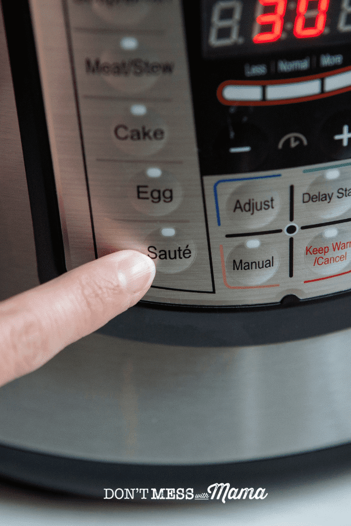 finger pointing to saute button on instant pot
