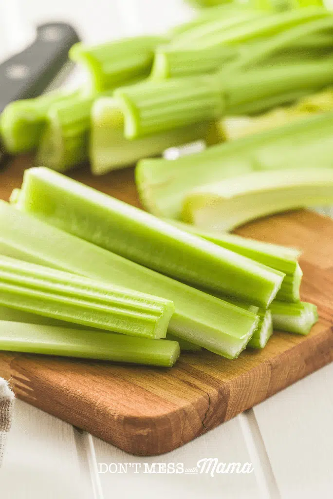 chopped celery sticks on board