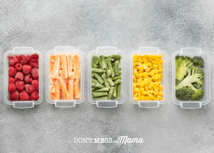 five plastic containers with frozen food on grey background