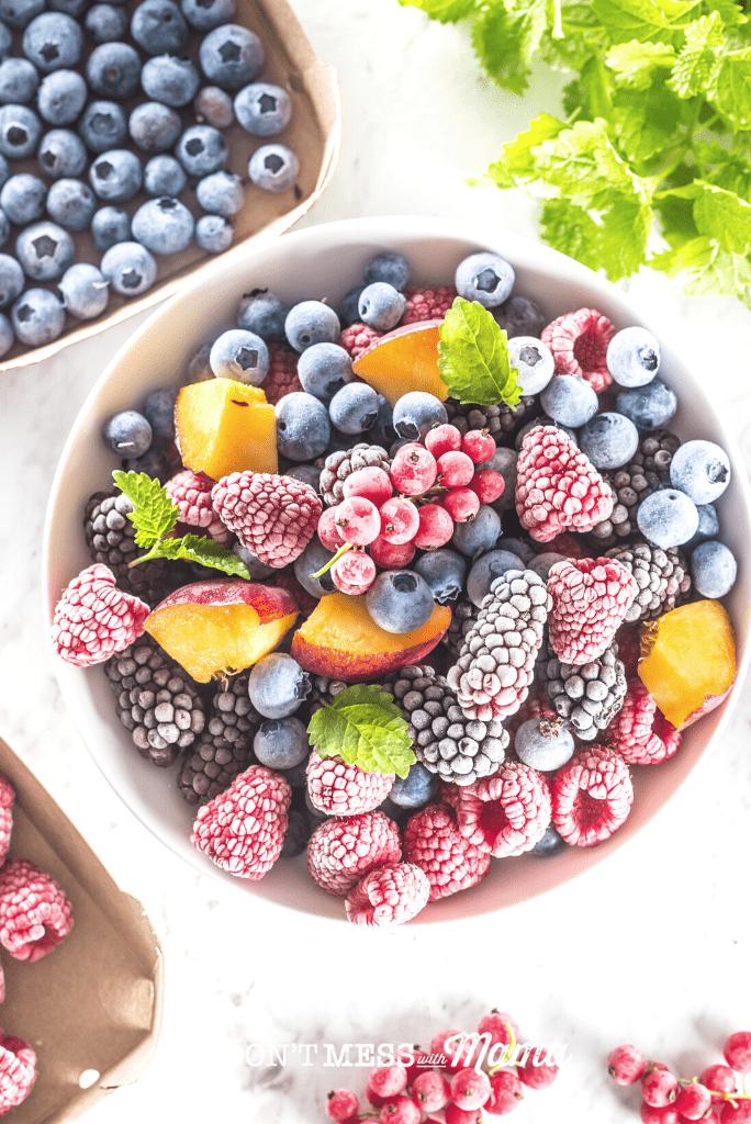 white bowl full of frozen berries