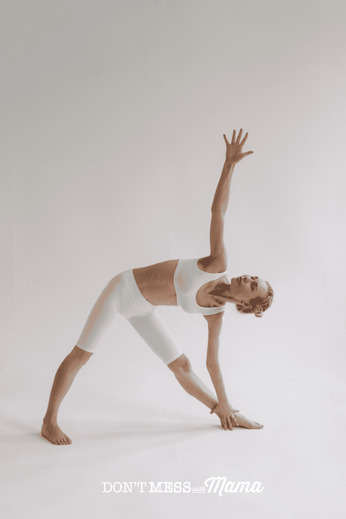 woman doing yoga wearing white pants and top