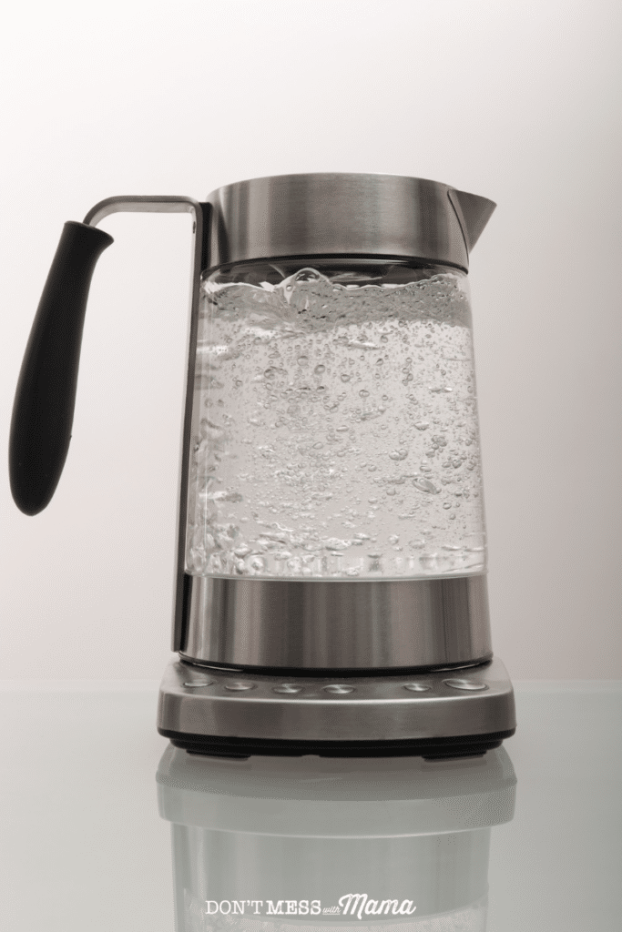 hot water kettle on a countertop with boiling hot water inside