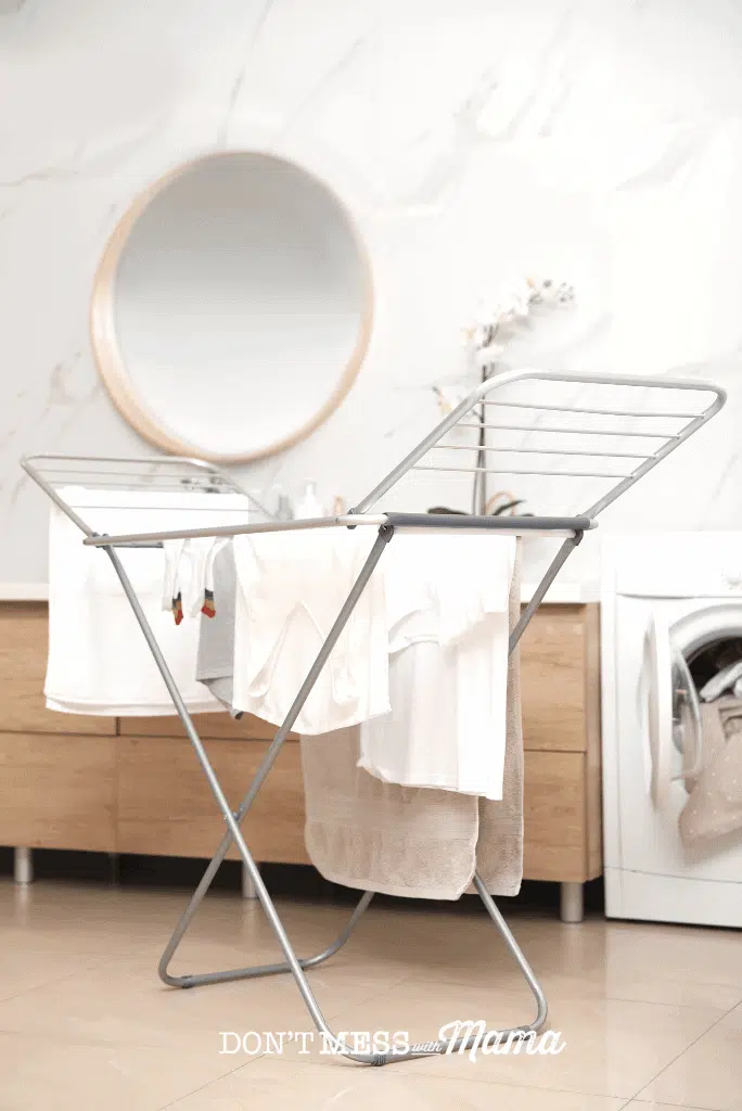 white laundry drying on clothes stand 