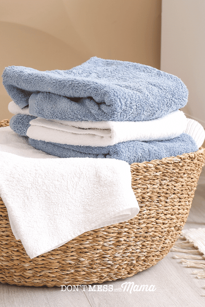 blue and white towels in jute laundry basket