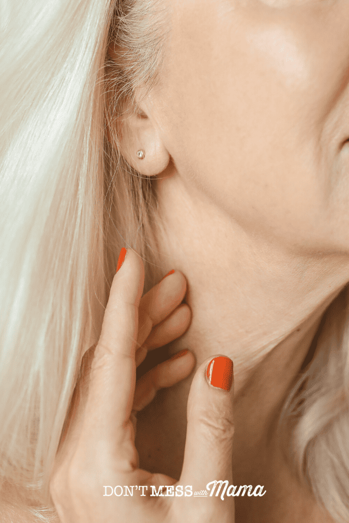 close up view of woman's jawline and glowing skin on cheek