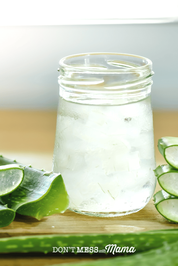 jar of aloe vera gel with pieces of plant