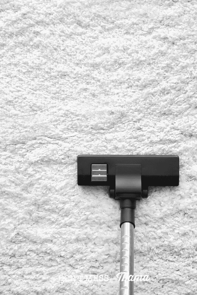 vacuum on white fluffy carpet