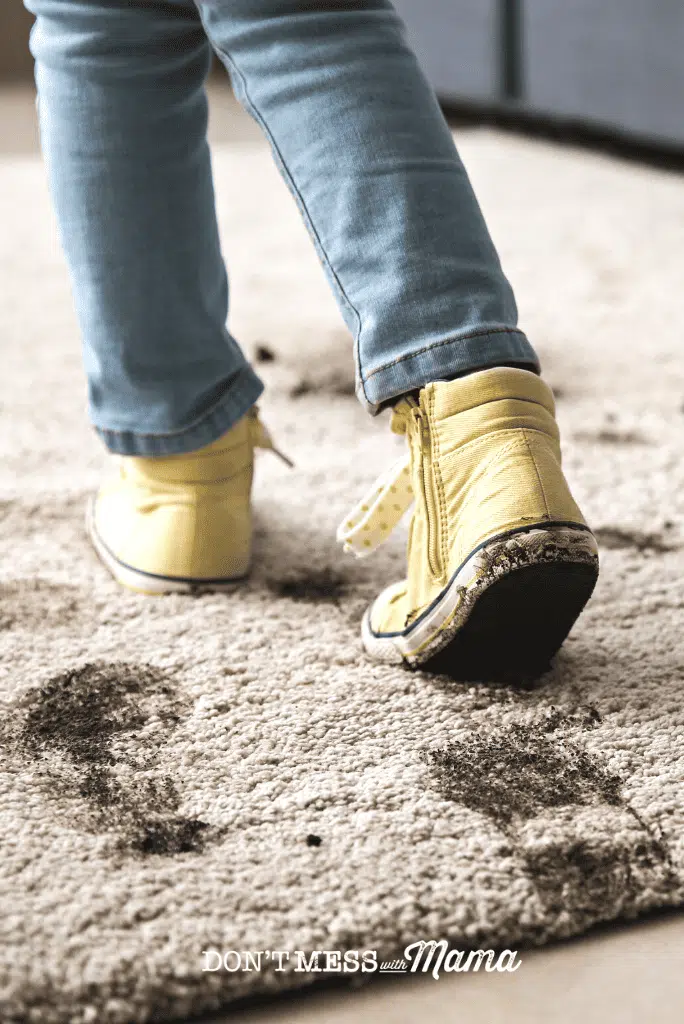 yellow sneakers stamping mud on carpet