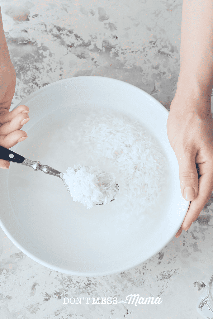 hand mixing rice and water with spoon