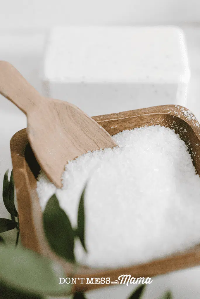 wooden bowl of sea salt with wooden spoon