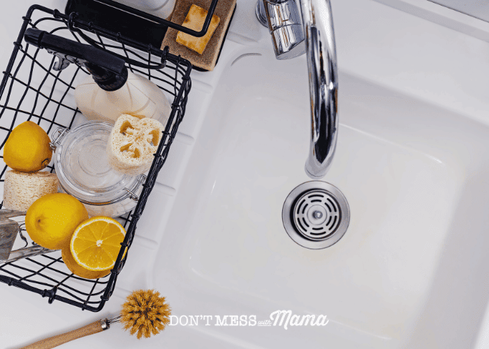 clean sink with lemons and baking soda on counter