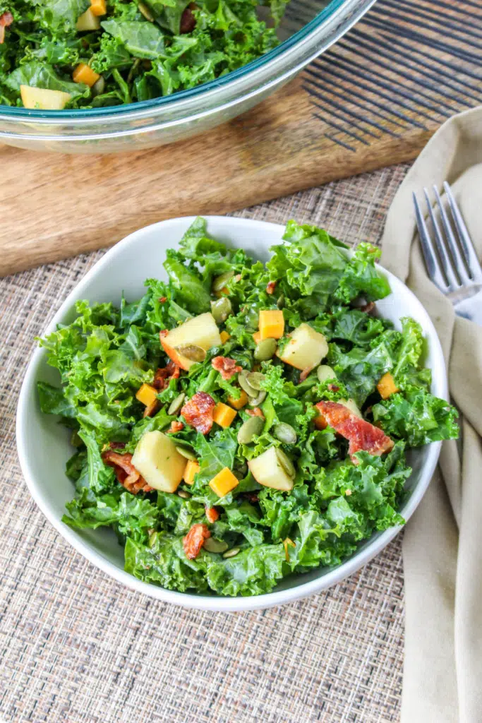 serving up a kale salad with apples and cheddar